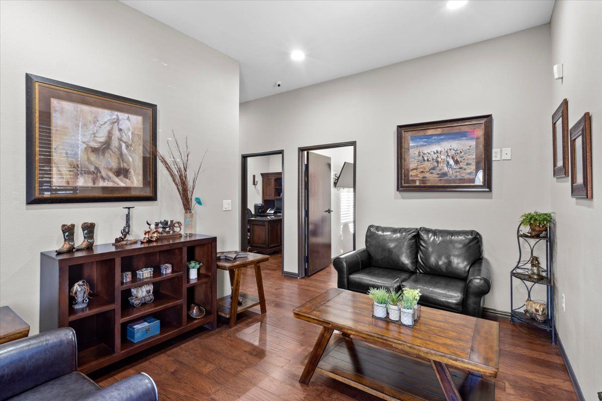 Waiting room with leather seating and wood-look floors