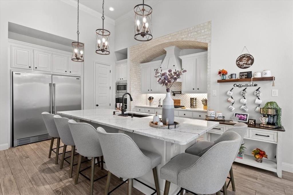 Kitchen island, built-in refrigerator and coffee bar