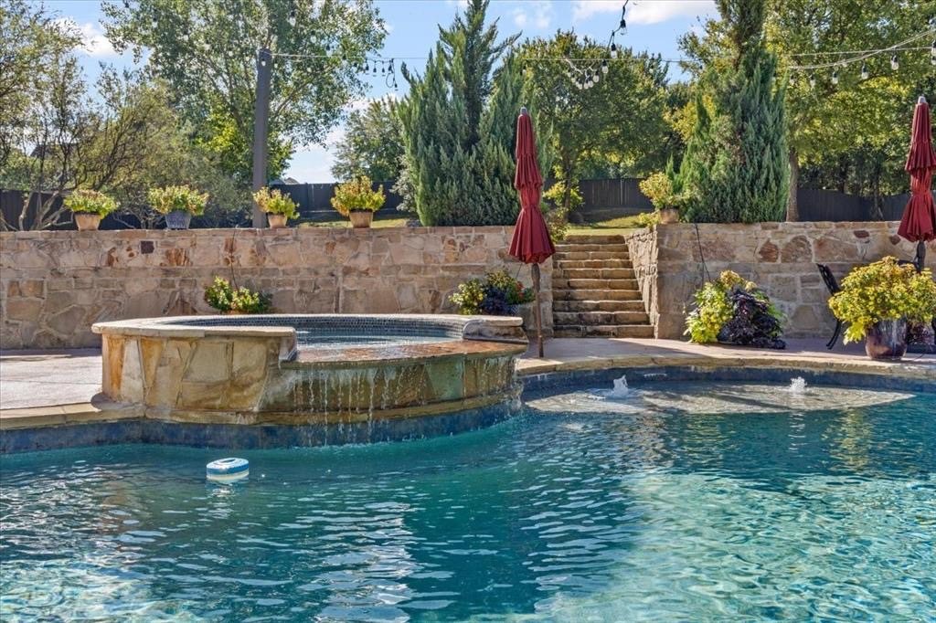 Heated pool and spa with stone retaining wall